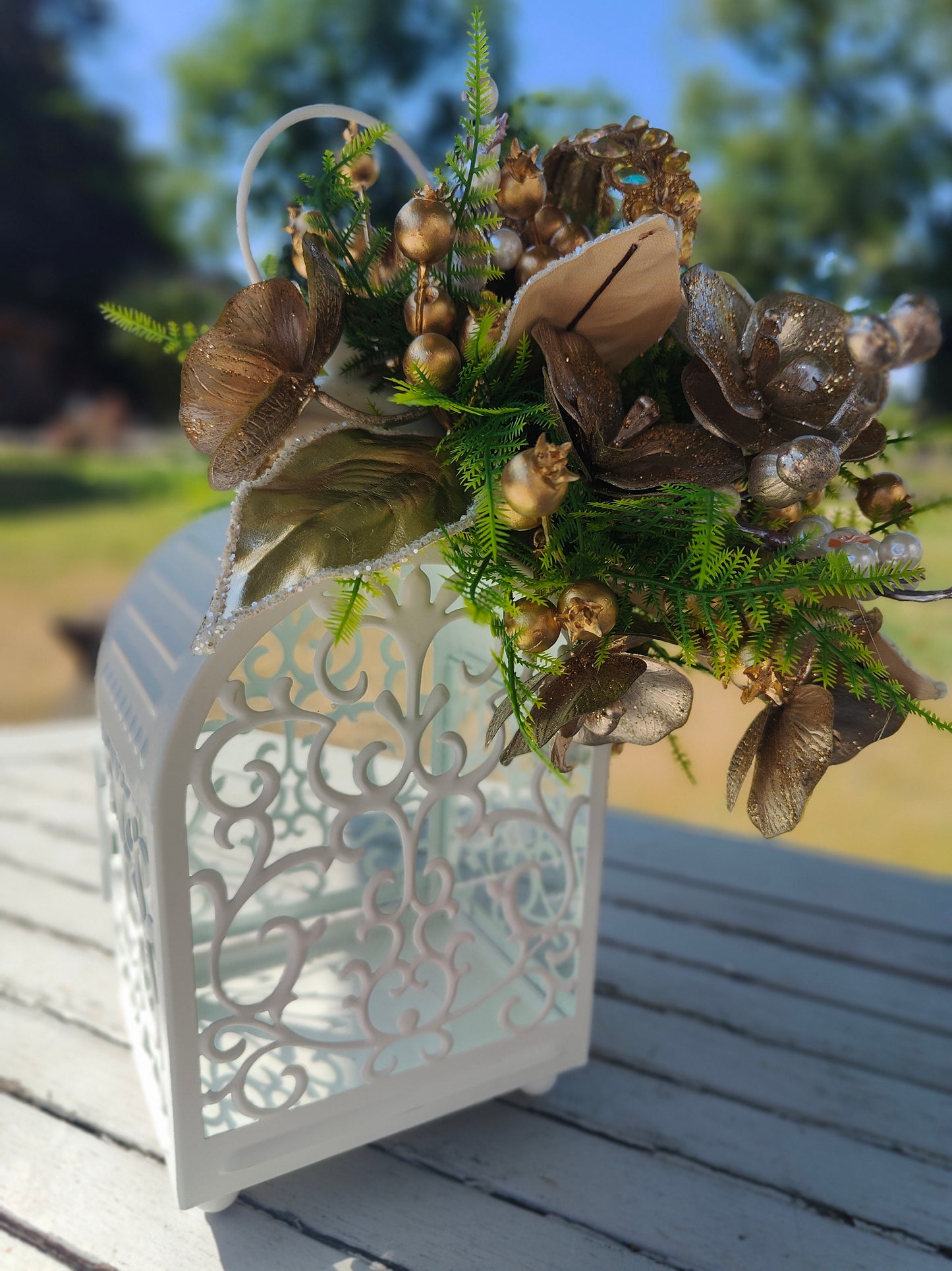 Lantern white and gold decorated tablecentre display. Gold and white lantern. Home decor arrangement
