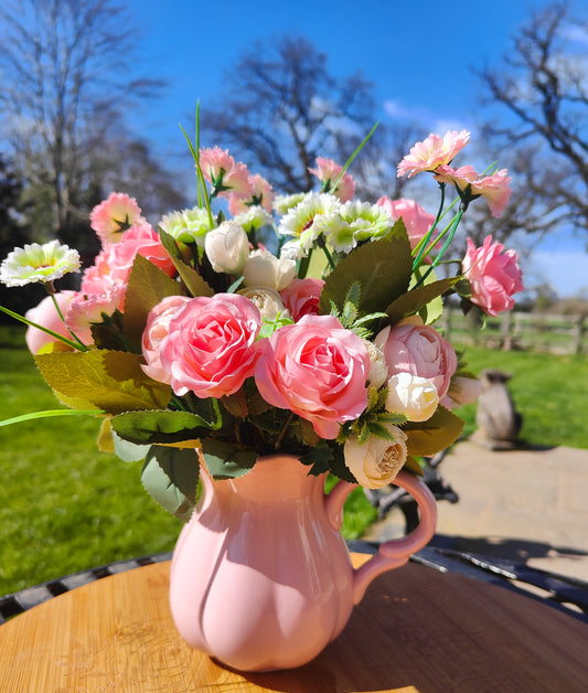 Flower arrangement artificial pink roses ranunculus in ceramic pink jug by Price & Kensington vintage