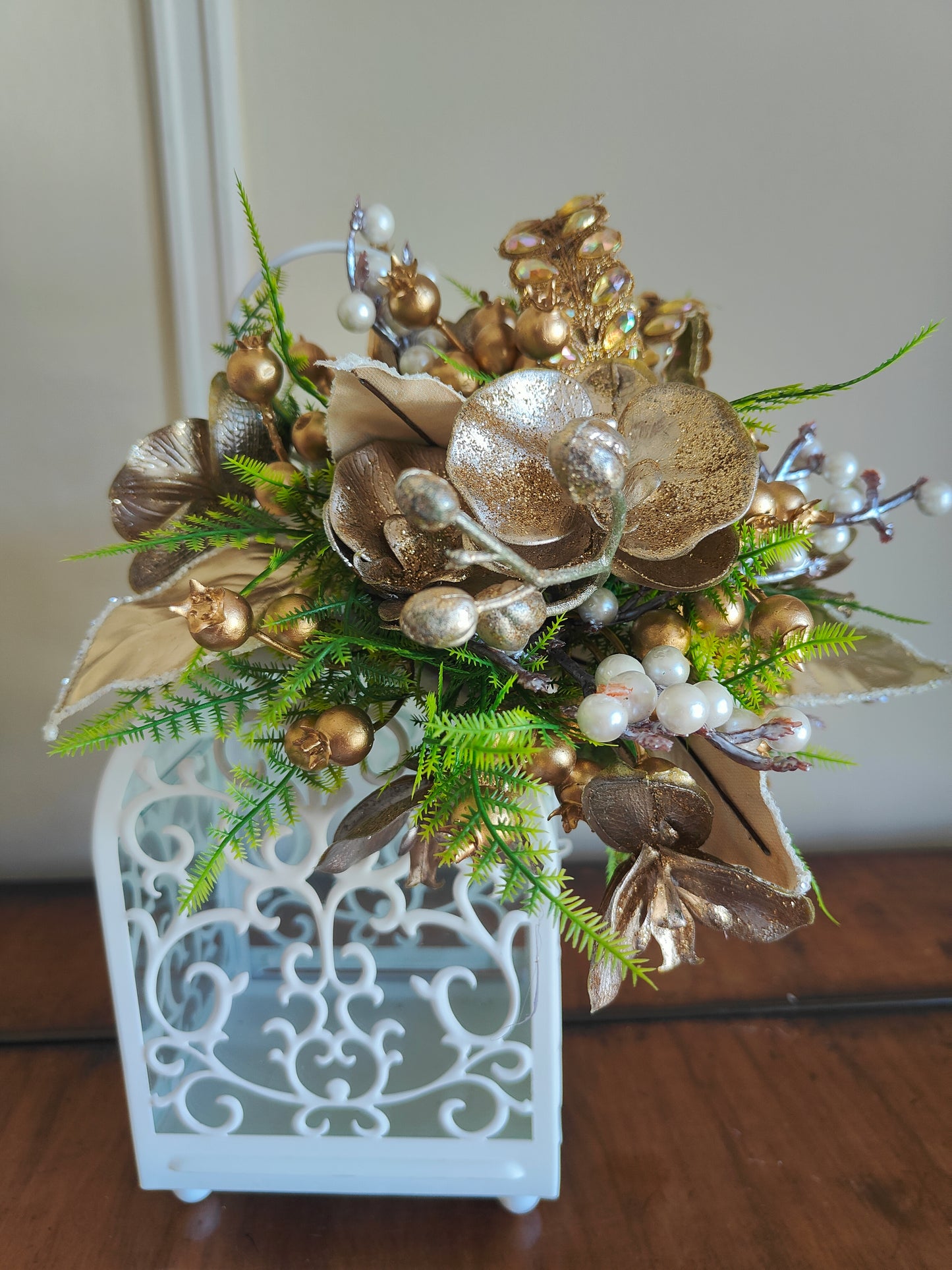 Lantern white and gold decorated tablecentre display. Gold and white lantern. Home decor arrangement