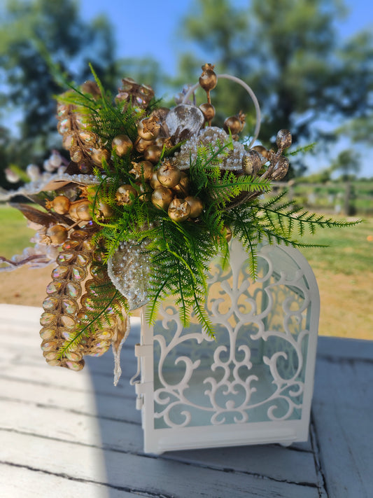 Lantern white and gold decorated tablecentre display. Gold and white lantern. Home decor arrangement